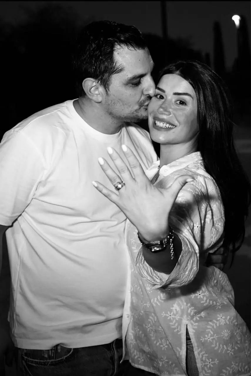 Panayiotis kissing Teo's cheek as she shows her engagement ring