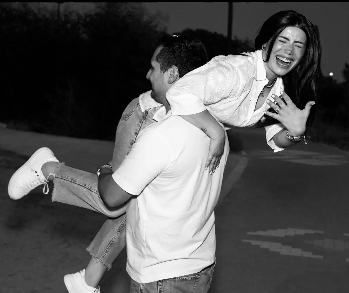 Panayiotis carrying Teo over his shoulder, both laughing